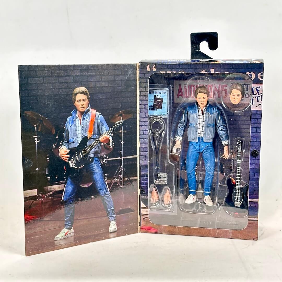 Action figure in packaging with a brick wall background