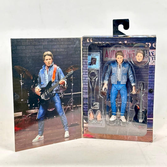 Action figure in packaging with a brick wall background