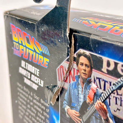 Toy figure of Marty McFly from 'Back to the Future' with a broken packaging box.