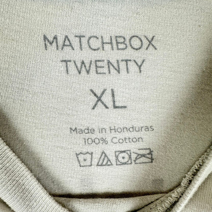 Close-up of the inner neck label of a light gray cotton garment, printed with the text 'MATCHBOX TWENTY XL'.