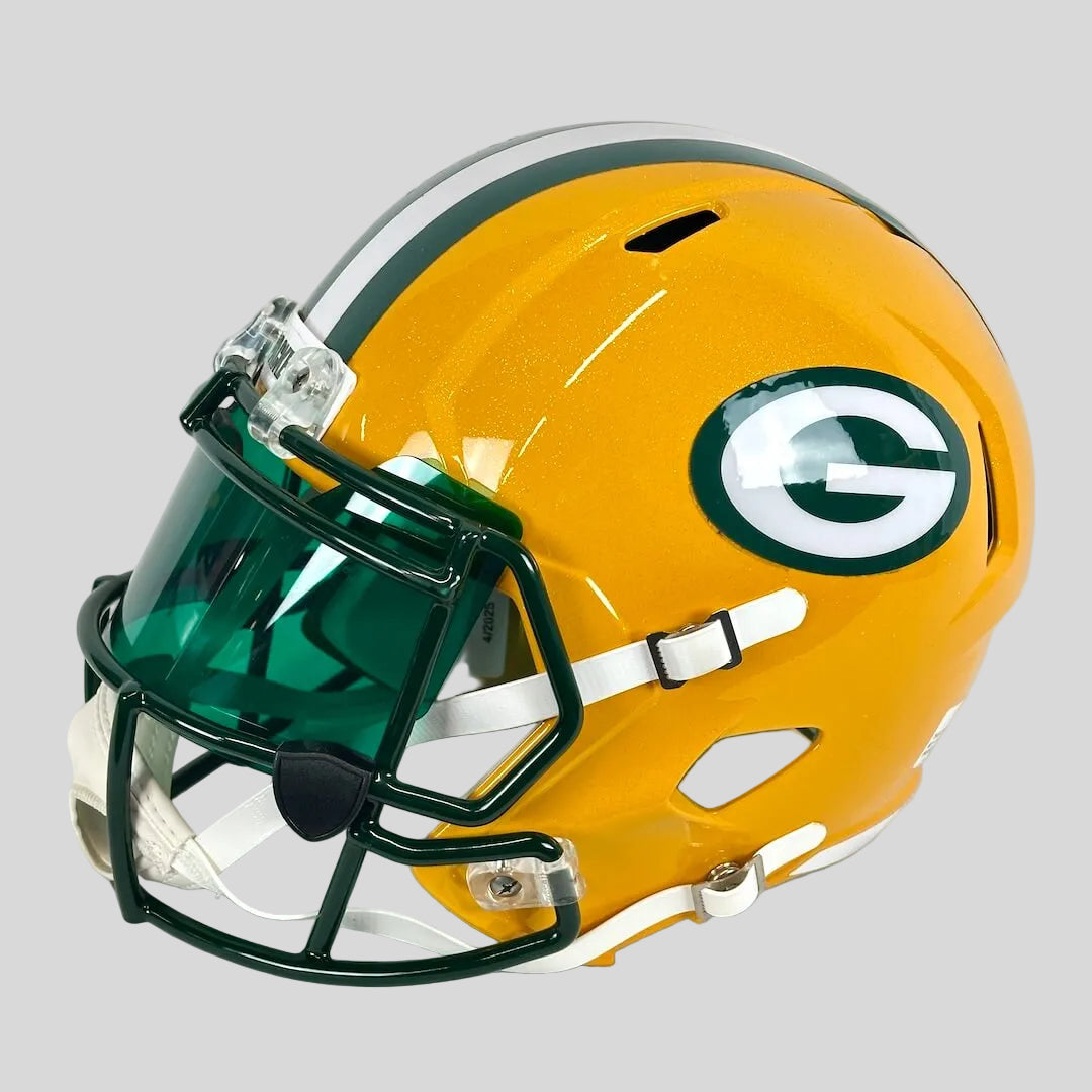 A Green Bay Packers full-face football helmet in yellow with a green and white facemask and a green visor.