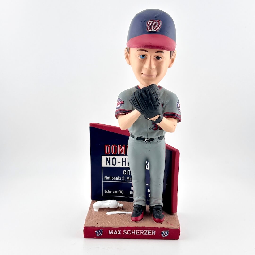 Bobblehead of a baseball player in uniform with a plaque on a white background