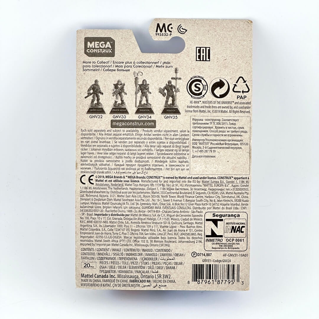 The back of a Mega Construx toy packaging card, showing product information and safety labels. 