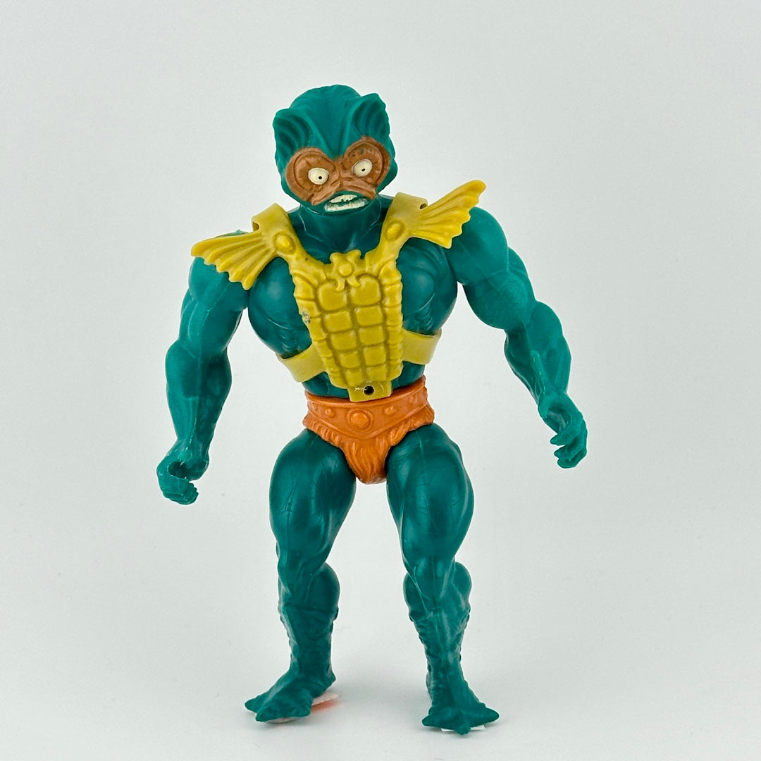 Turquoise male figure in orange loincloth with fur detail, and lime green battle harness accessory.