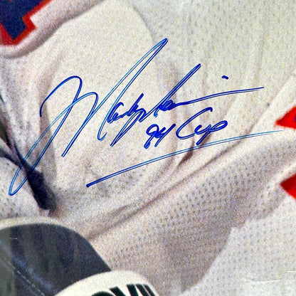 Close-up of a sports jersey with a signature and number on a blurred background