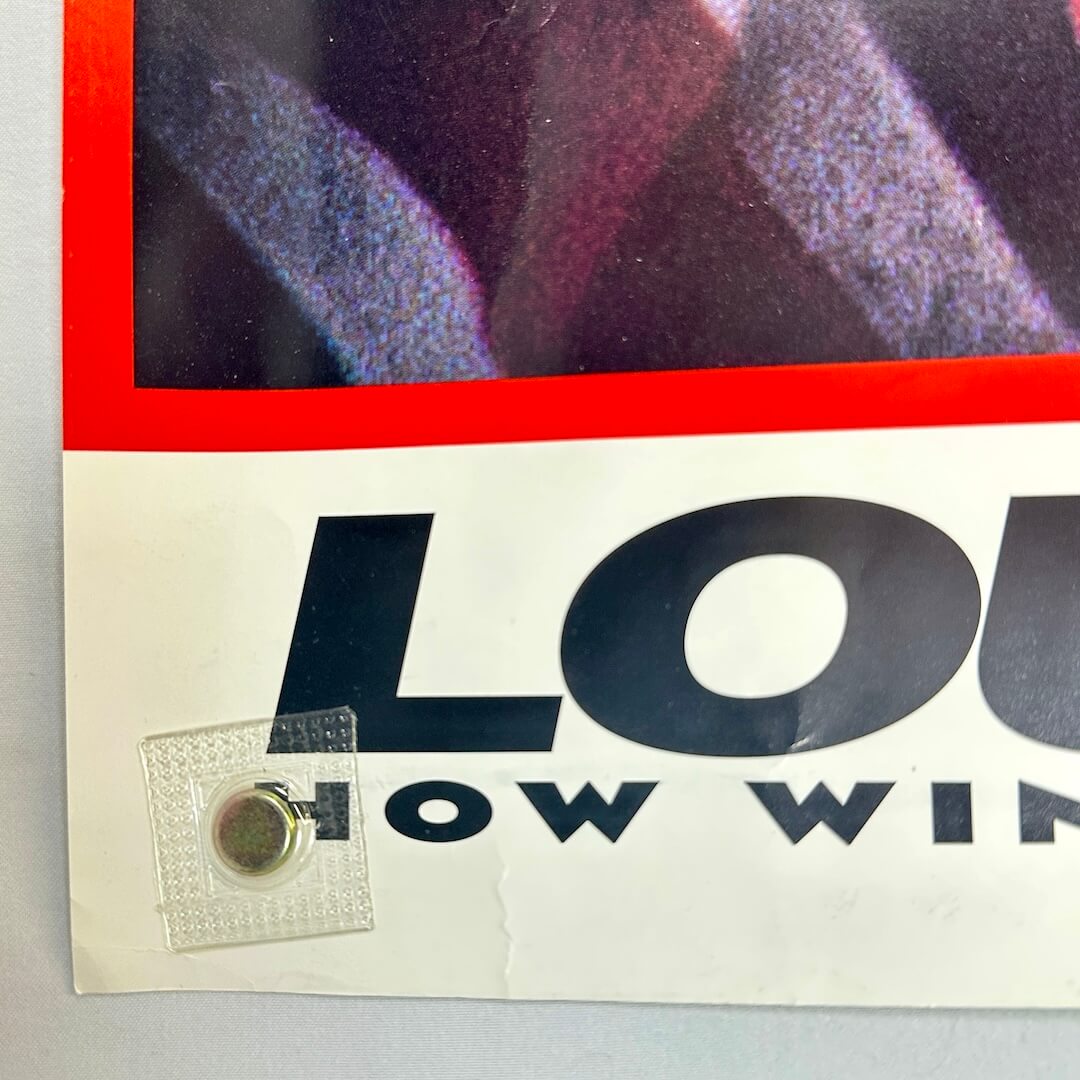 Bottom left corner of poster with crease two inches from corner. 
