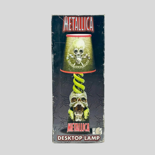 Metallica desktop lamp packaging with skull and snake design on a gray background
