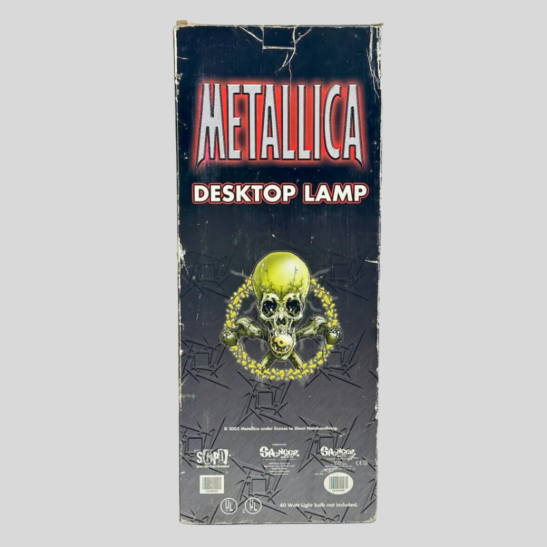 Metallica desktop lamp packaging with skull and crossbones design on a white background