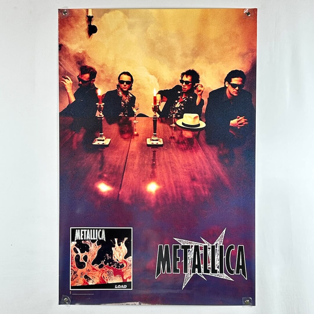Metallica poster with band members around a table and album cover at the bottom.