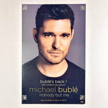 Poster of man staring into camera with text at bottom detail artist and album information. 