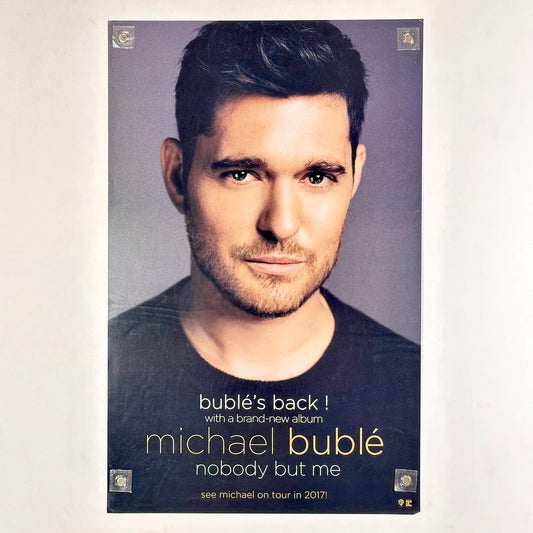 Poster of man staring into camera with text at bottom detail artist and album information. 