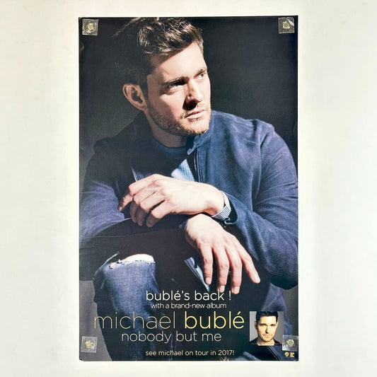 Poster of a man kneeling with his hands on his knee with artist and album name along bottom. 