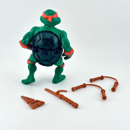 TMNT turtle action figure with accessories on white background. 