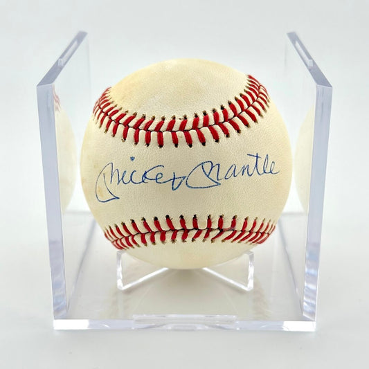 Signed baseball in clear display cube against white background.