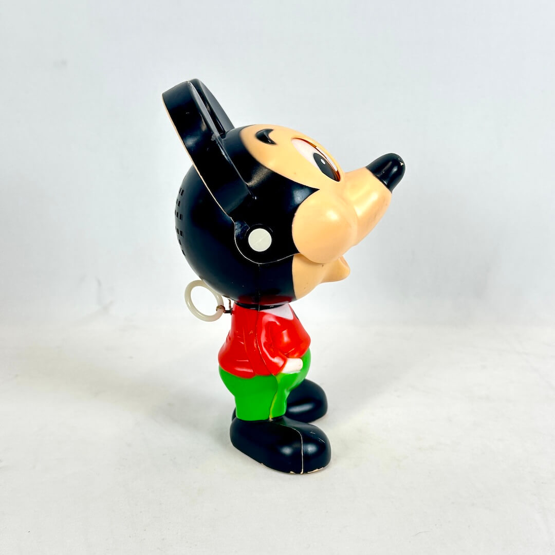 Vintage toy figure of a character with a black hat and red shirt on a white background