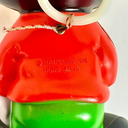 Close-up of a character with a red top and green bottom, featuring a 'Mattel Inc. 1976 Hong Kong' label.