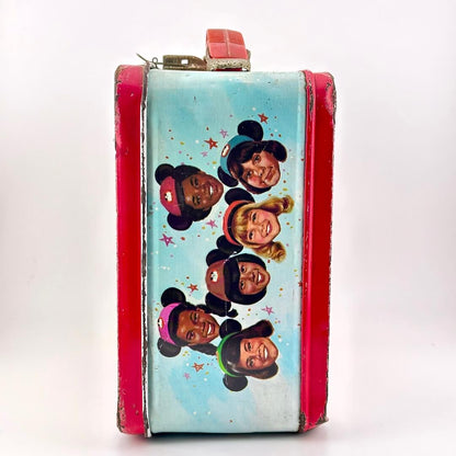 Side view of metal lunchbox with images of children's faces wear Mickey Mouse ears. 