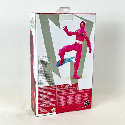 Back of packaging with image of posed action figure with warning labels and product information. 