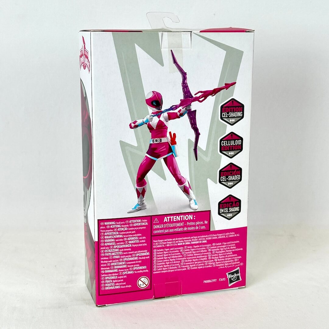 Back of packaging with image of posed action figure above warnings and product information. 