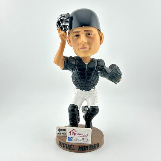 Bobblehead of a baseball player in a catcher's uniform with a helmet on a white background