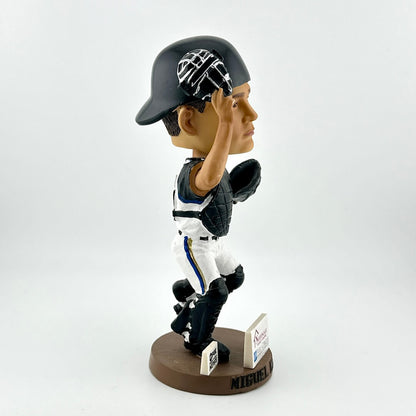 Bobblehead of a baseball player in a catcher's uniform on a white background
