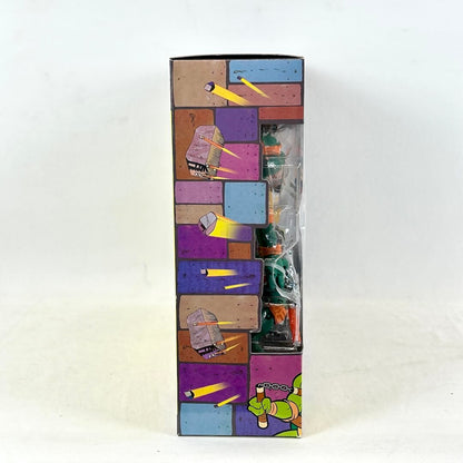 Side view of packaging with animated bricks flying from window, photographed on light background. 