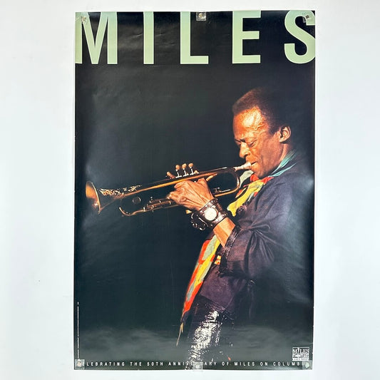 Promo poster for Miles Davis with his name above an image for him playing instrument. 