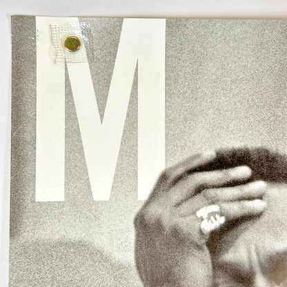 Top left corner of poster with pin holes. 