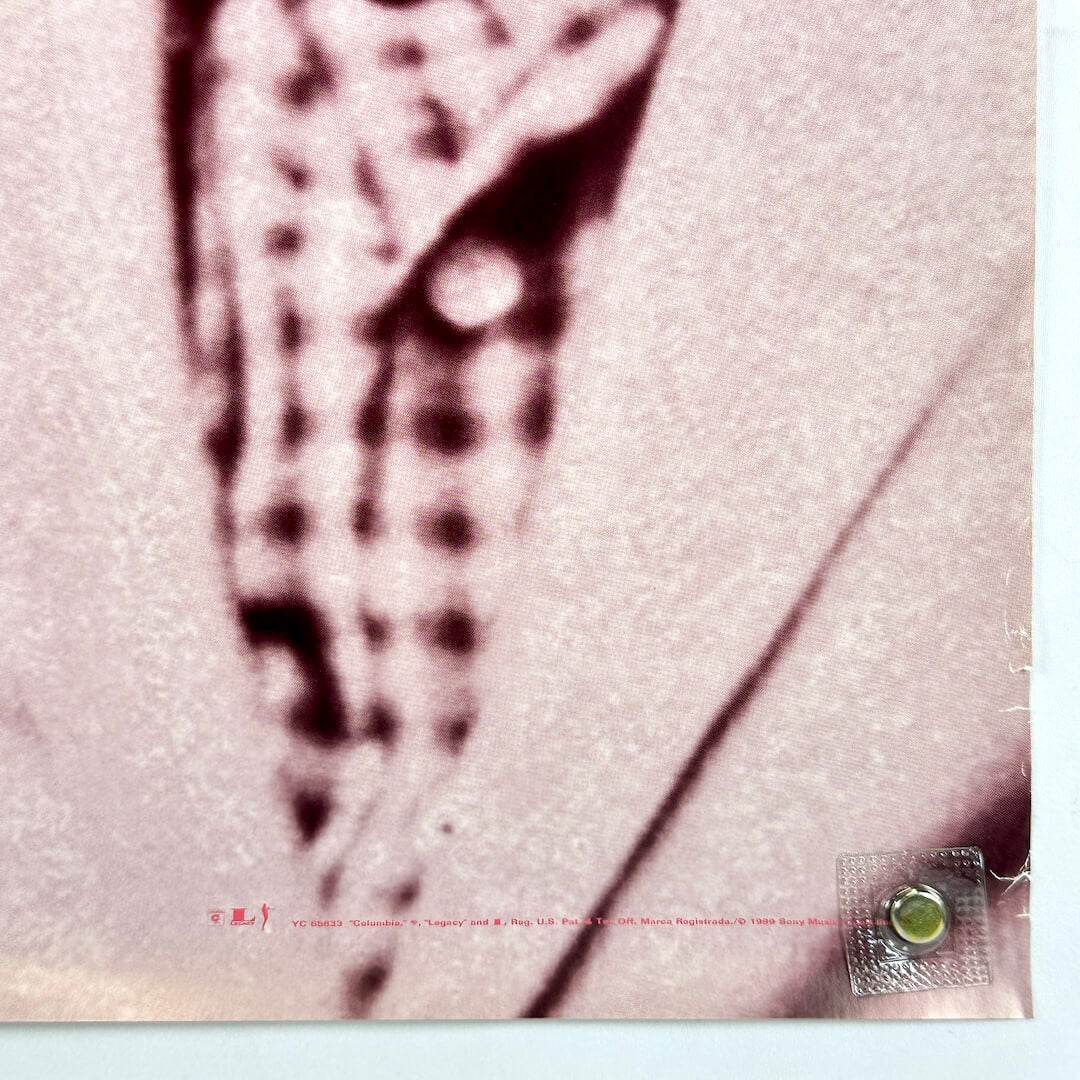 Bottom right corner of poster with creasing. 