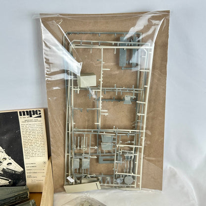 Model kit packaging with metal parts on a cardboard backing, featuring the MPC brand.
