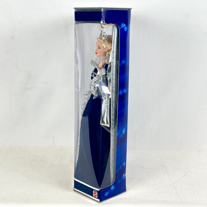 Doll in a blue and clear box on a white background