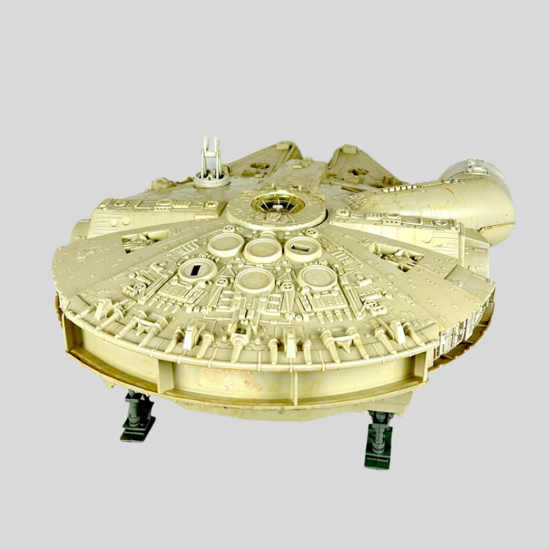 Millennium Falcon toy against light gray background. 