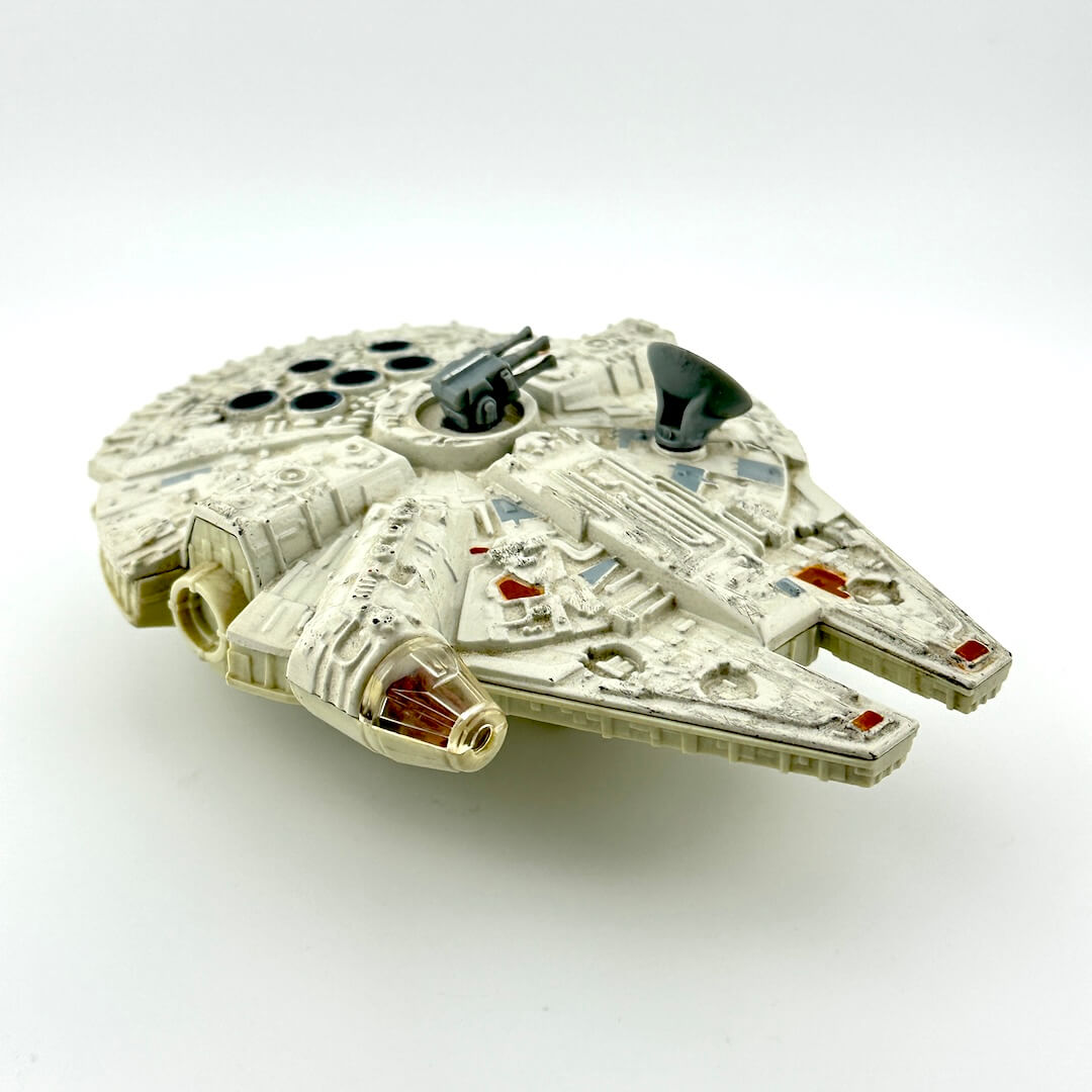 Diecast model of a spaceship of the Millennium Falcon on a white background