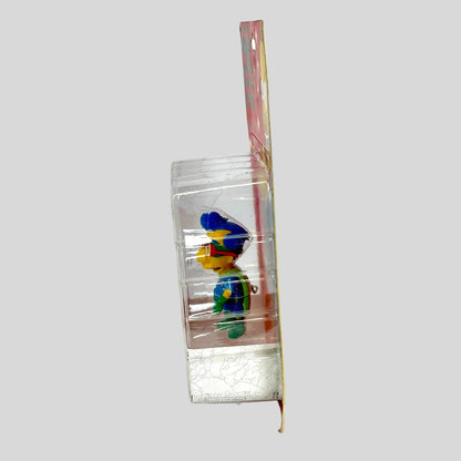 Colorful toy figure in a clear plastic packaging on a white background