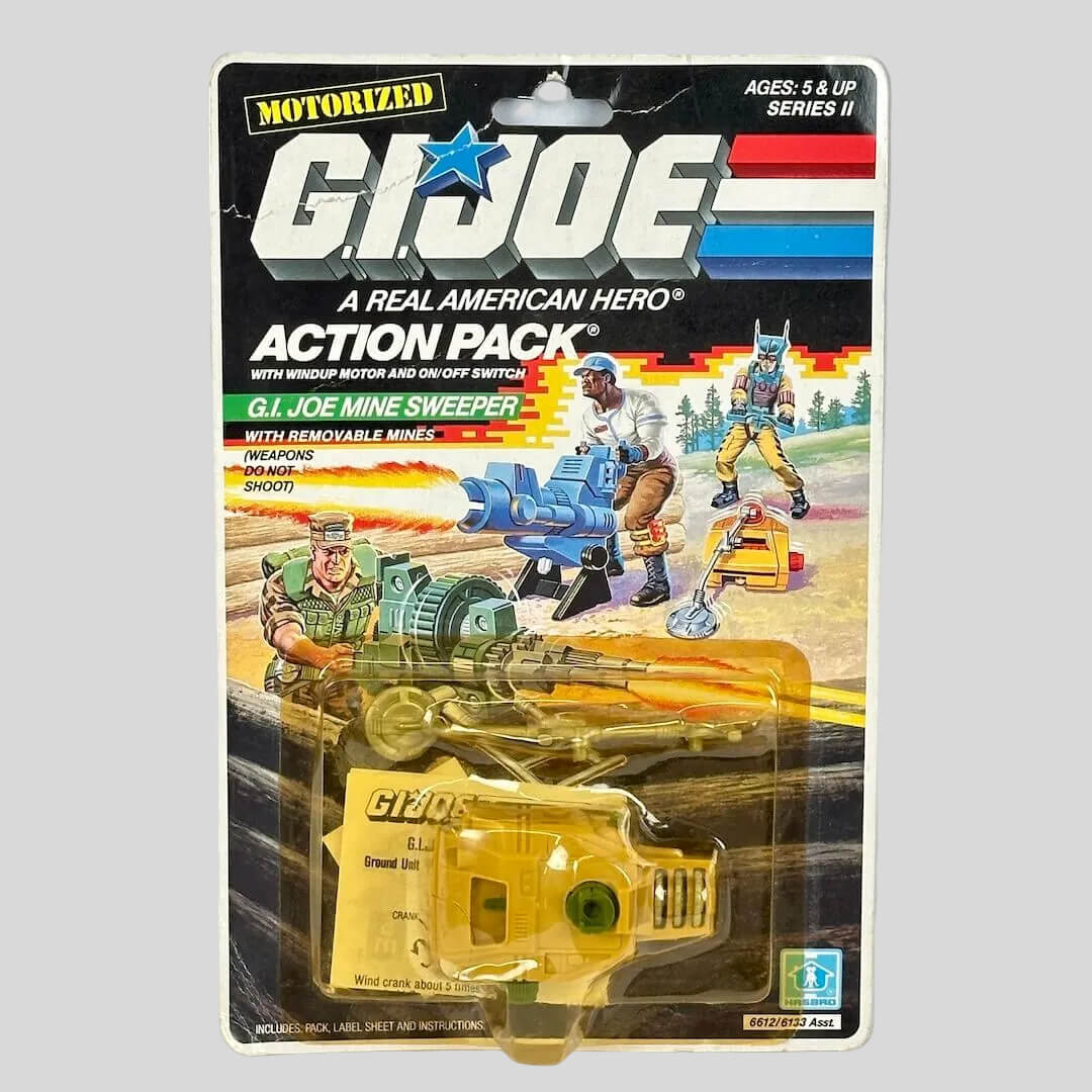 G.I. Joe toy in packaging against gray background. 