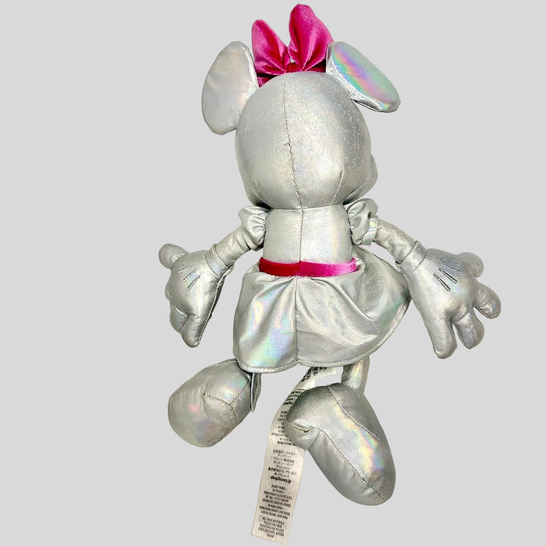 Silver plush toy with pink bow on a white background