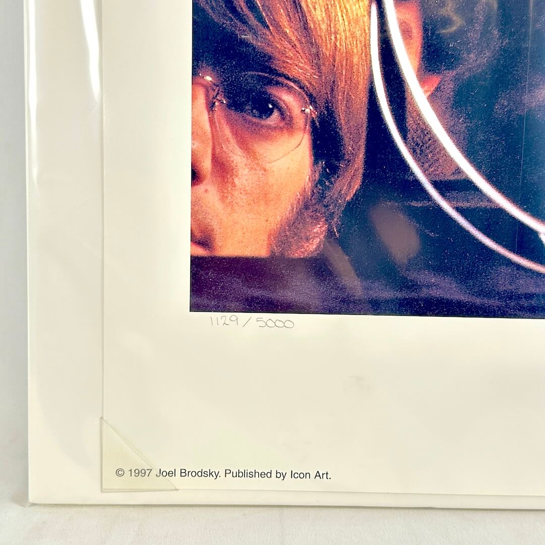 Bottom left corner of print tucked into protective corner, sleeved in plastic. 