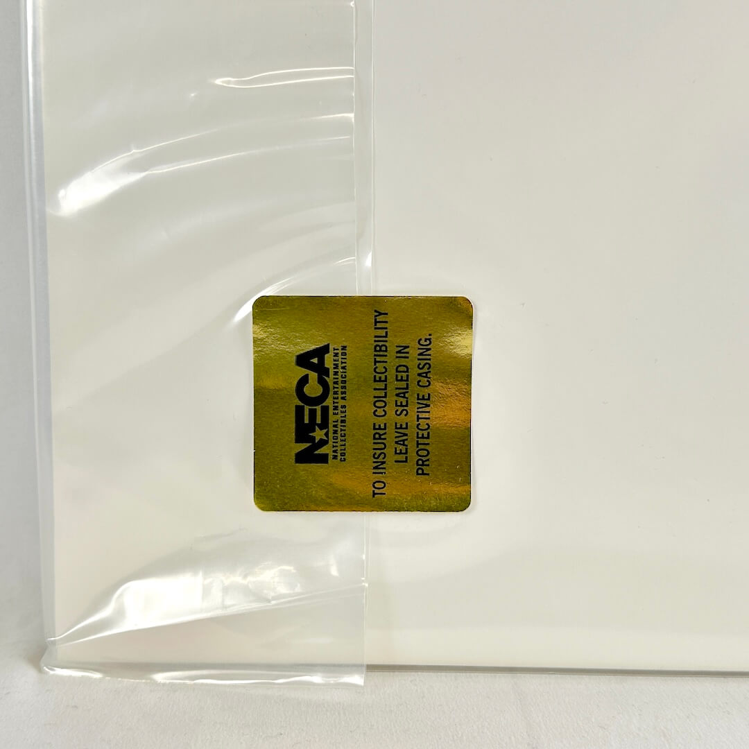 Gold NECA label on a clear plastic bag with white background