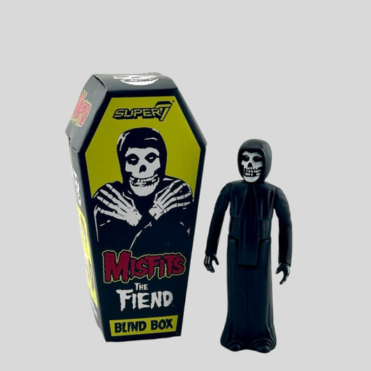 Coffin shaped box for Crimson Ghost figure option next to it, a skeleton wearing a long black robe. 