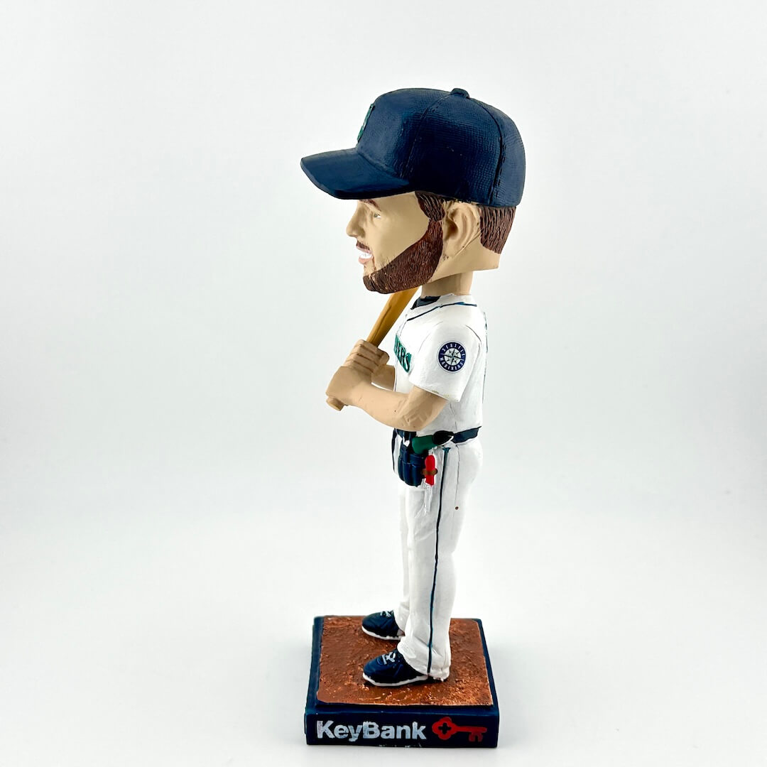 Bobblehead of a baseball player in uniform with a bat, on a white background