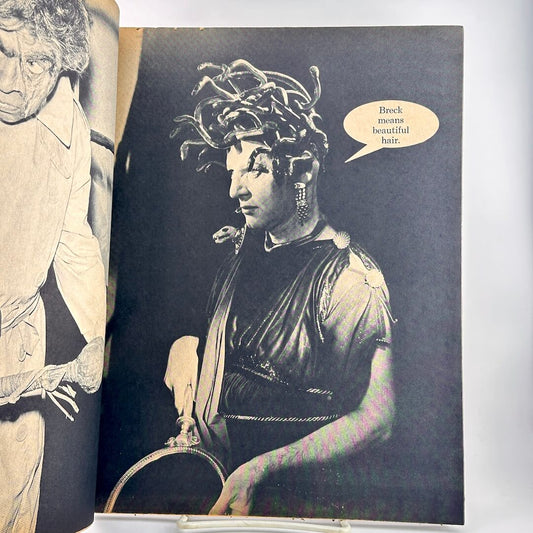 An open vintage magazine showing a black-and-white photo of a woman with elaborate hair and a speech bubble.
