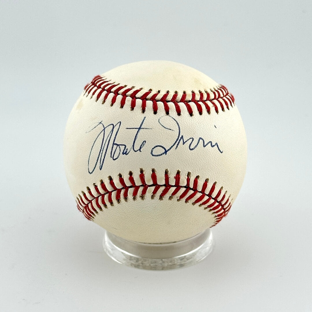 Baseball with autograph on a clear stand against a light gray background