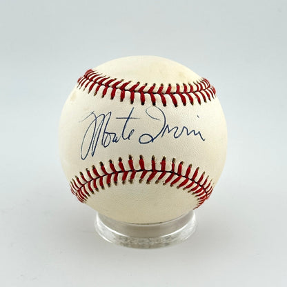 Baseball with autograph on a clear stand against a light gray background