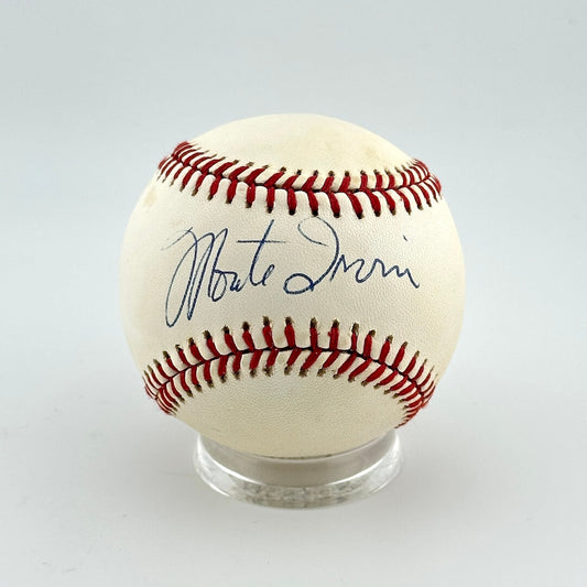 Baseball with autograph on a clear stand against a light gray background