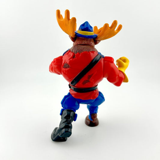 Figurine of a moose character in a red shirt and blue pants on a white background