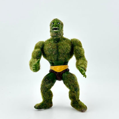 Green flocked action figure against white background.