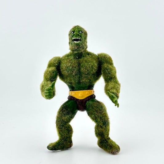 Green flocked action figure against white background.