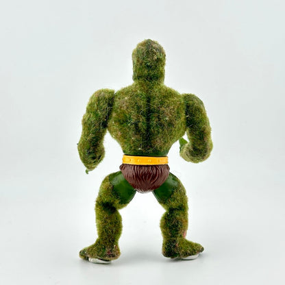 Faux Moss-covered figure with a yellow belt on a white background