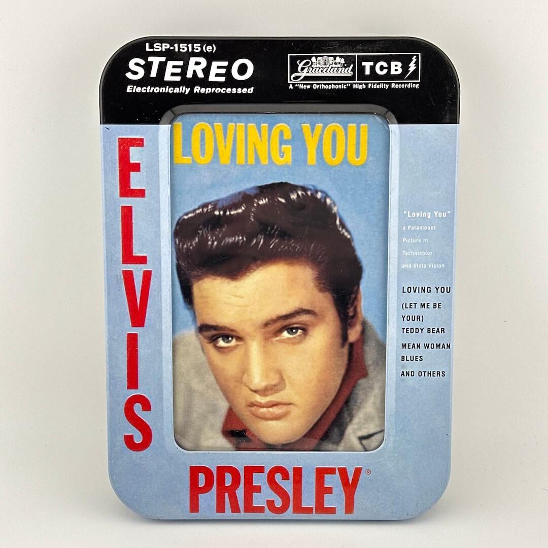 Elvis Presley album cover with a portrait and text on a light blue background