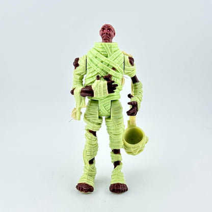 Action figure of a character in green costume with brown accents on a white background